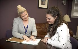 DIRECTOR OF THE ASPIRE CLINIC MEGAN FORD, LEFT, DISCUSSES A CASE WITH STUDENT PAIGE GARRISON. 