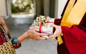 Elderly Hand Giving Graduation Gift