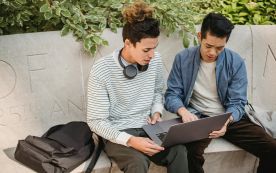 A graduate student reviews financial aid documents as federal loan 