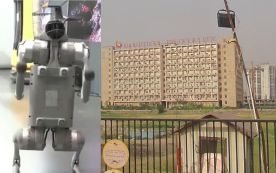 Robot dog (left) stands on display at the India AI 