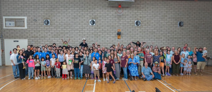 Students and local Anza church members pose for a group 