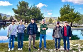 Volunteers pose in front of the Pathfinder Ranch's Lied Lake